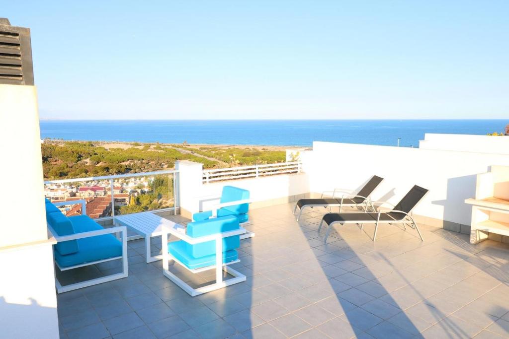 a balcony with chairs and a view of the ocean at Nova Beach Paradise Apartment in Gran Alacant