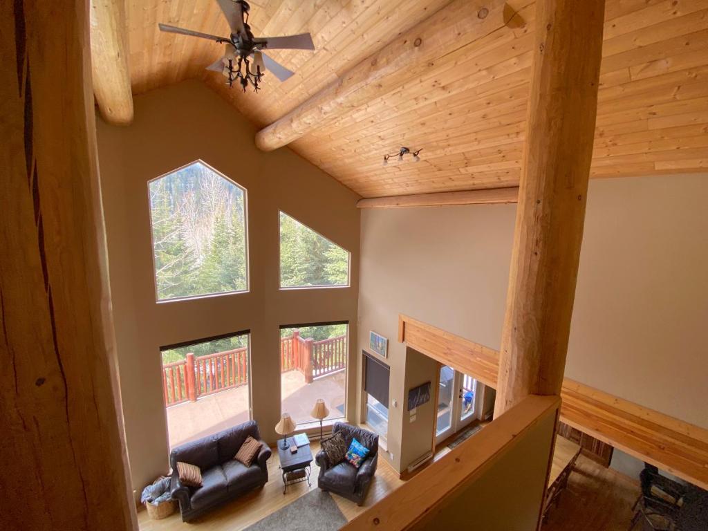 an overhead view of a living room with a large window at Morrisey Chalet at Sun Peaks in Sun Peaks