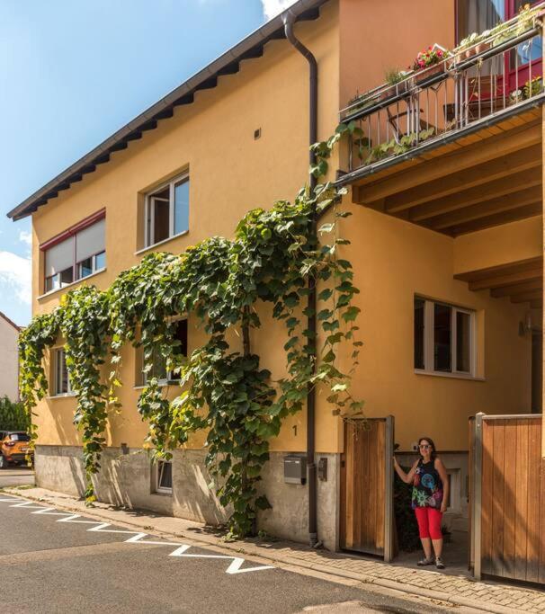 a woman standing in the doorway of a building at Unter den Reben in Niederkirchen bei Deidesheim