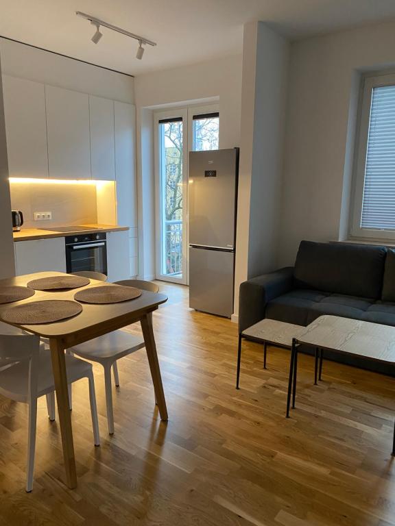 a living room with a table and a couch at Apartament Otwarta Wrocław in Wrocław