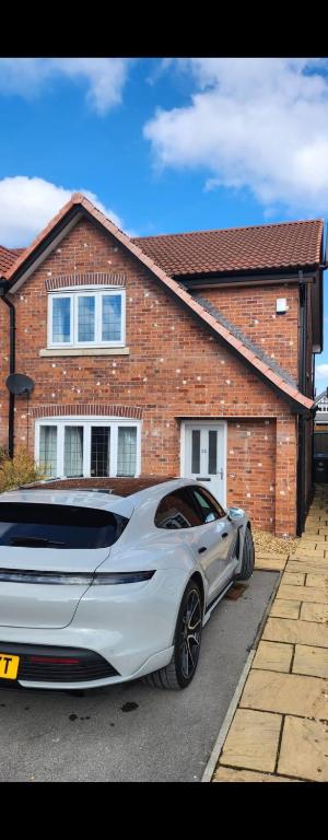 a white car parked in front of a house at Moorgreen in Bircotes