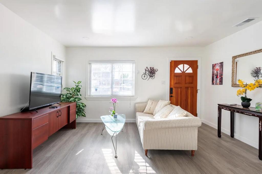 a living room with a couch and a tv at Newly Renovated 2BR 1BA Near San Jose Downtown up to 20 percent off in San Jose