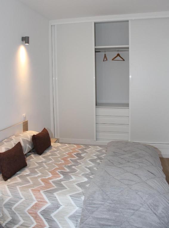a bedroom with a bed and a window and a closet at Los palomares in El Casar de Talamanca
