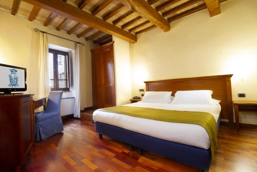 Postel nebo postele na pokoji v ubytování Relais La Corte di Bettona