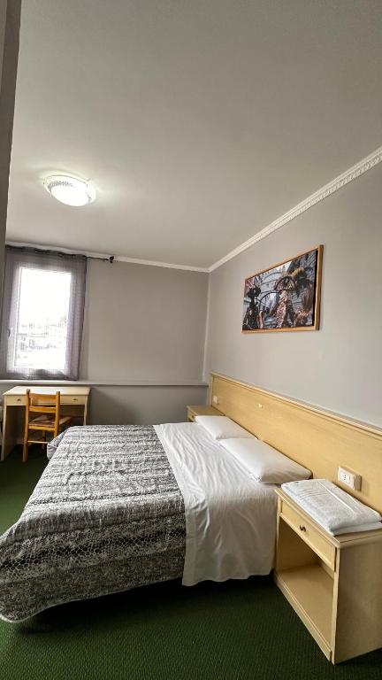 Postel nebo postele na pokoji v ubytování Nuova Locanda Belvedere
