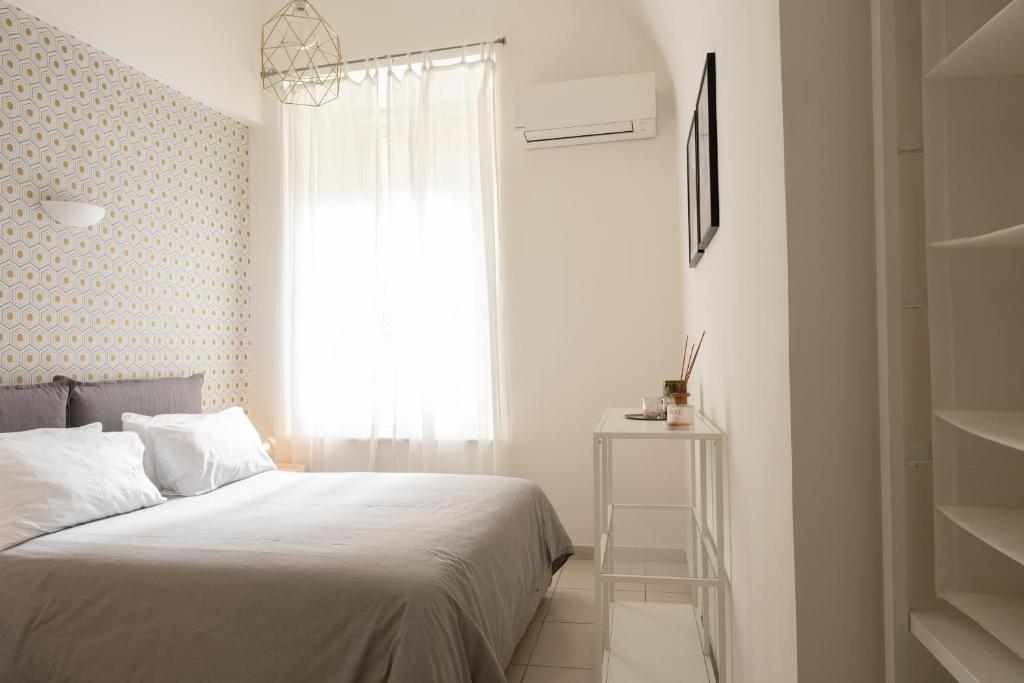 Postel nebo postele na pokoji v ubytování San Liborio Suites