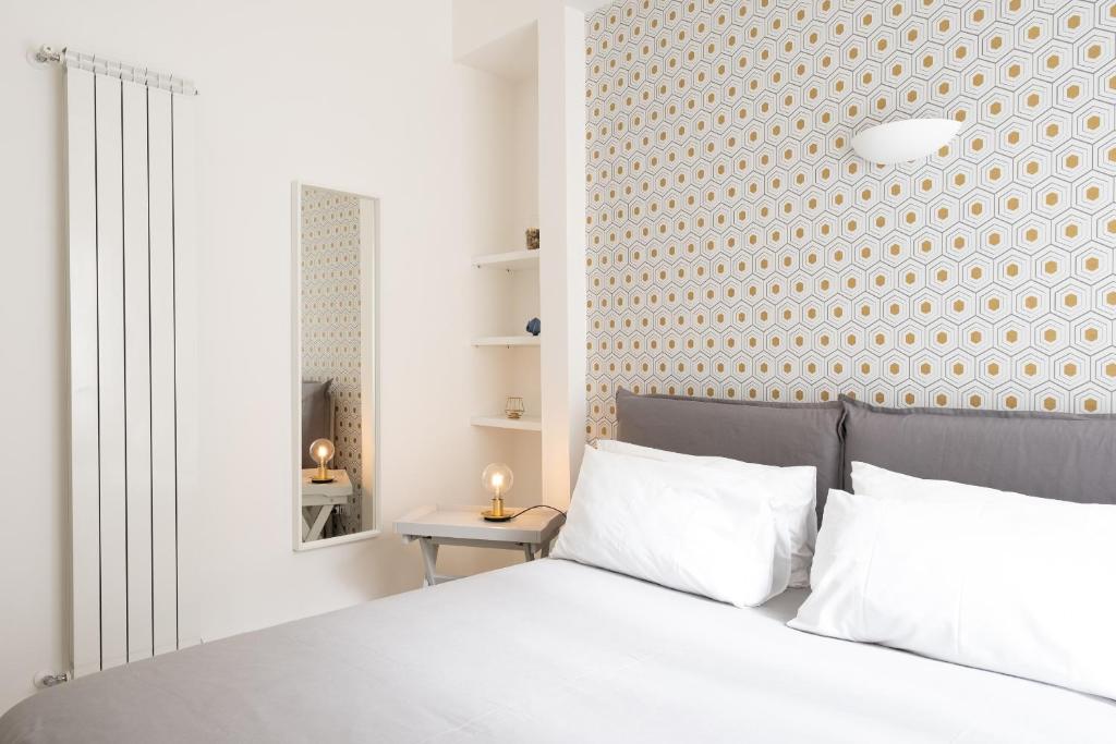Postel nebo postele na pokoji v ubytování San Liborio Suites