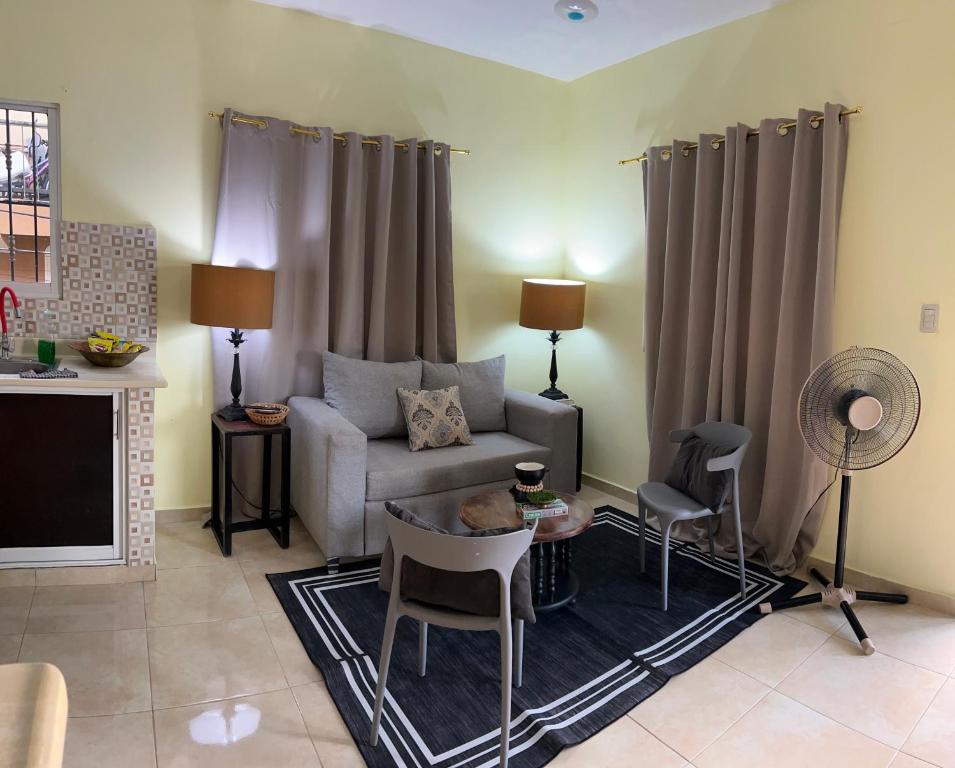a living room with a couch and a table and chairs at J&W apartment in San Felipe de Puerto Plata