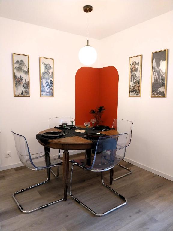 ein Esszimmer mit einem Tisch und Stühlen in der Unterkunft Gîte-appartement RDC La Ville au Monnier in Pleurtuit