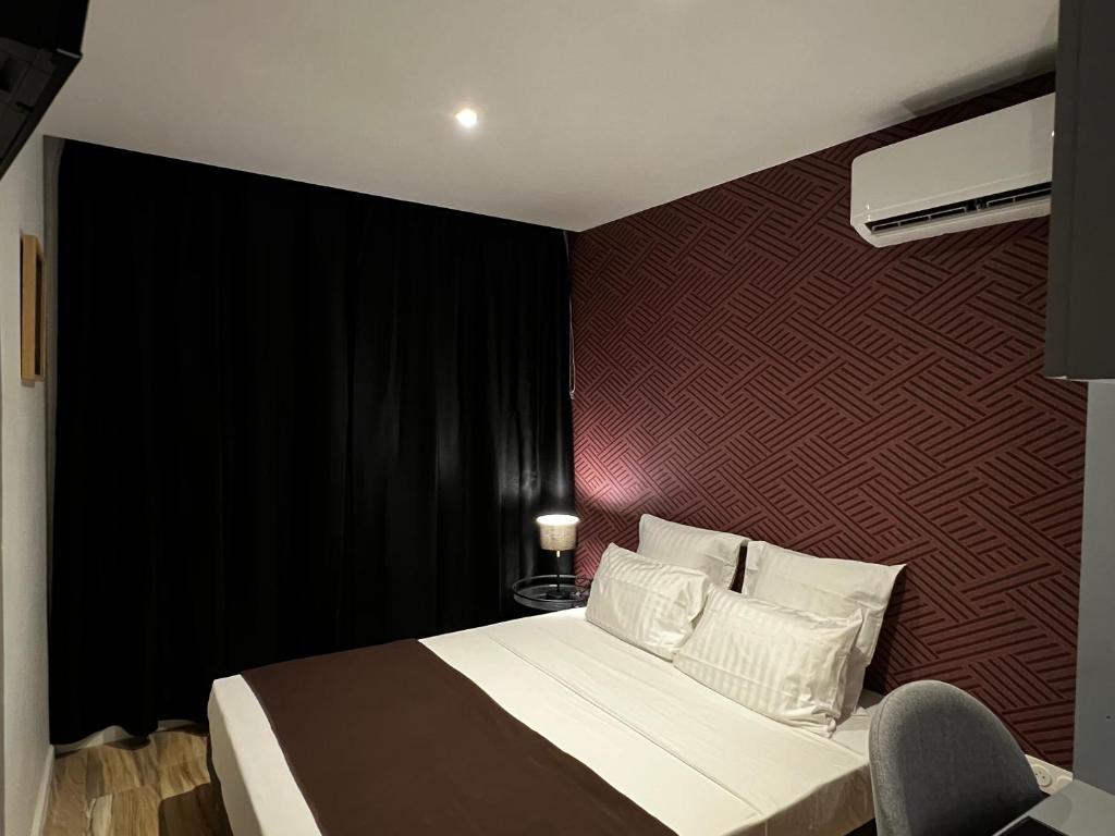 Postel nebo postele na pokoji v ubytování Chambre Rétro-pop en colocation