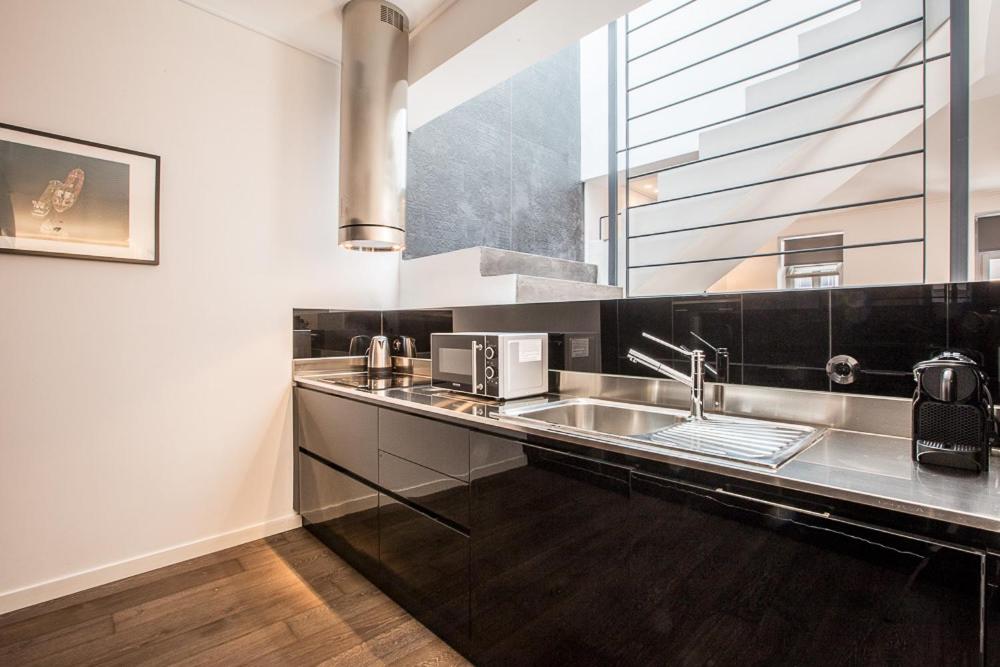 a kitchen with a sink and a window at Pink Mango in Athens