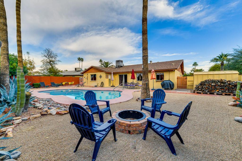 a group of chairs sitting around a fire pit next to a pool at Mesa Outdoor Oasis with Private Pool and Patio! in Mesa