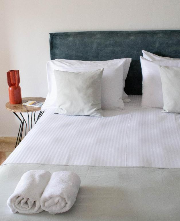 a bed with two white towels on it at Oniropetra Luxury Suites in Kastéllion