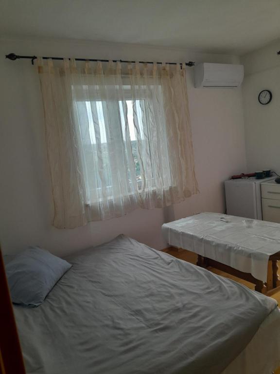 a bedroom with two beds and a window at apartmaj strunjan in Portorož