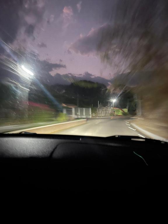a view from a car windshield of a road at night at Vangau in Esquipulas