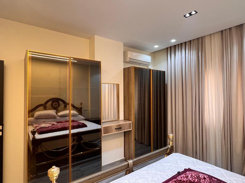 a bedroom with a glass closet with a bed in it at الدقي - القاهرة in Cairo