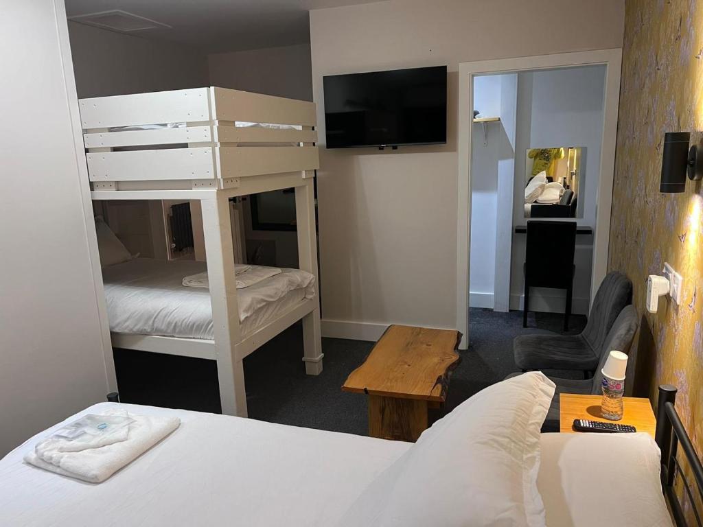 a bedroom with a bunk bed and a bedroom with a desk at Woolaway 2 in Taunton