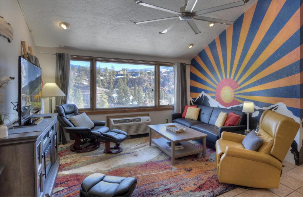 a living room with a blue couch and chairs at Tamarron Lodge Suite 502 in Durango