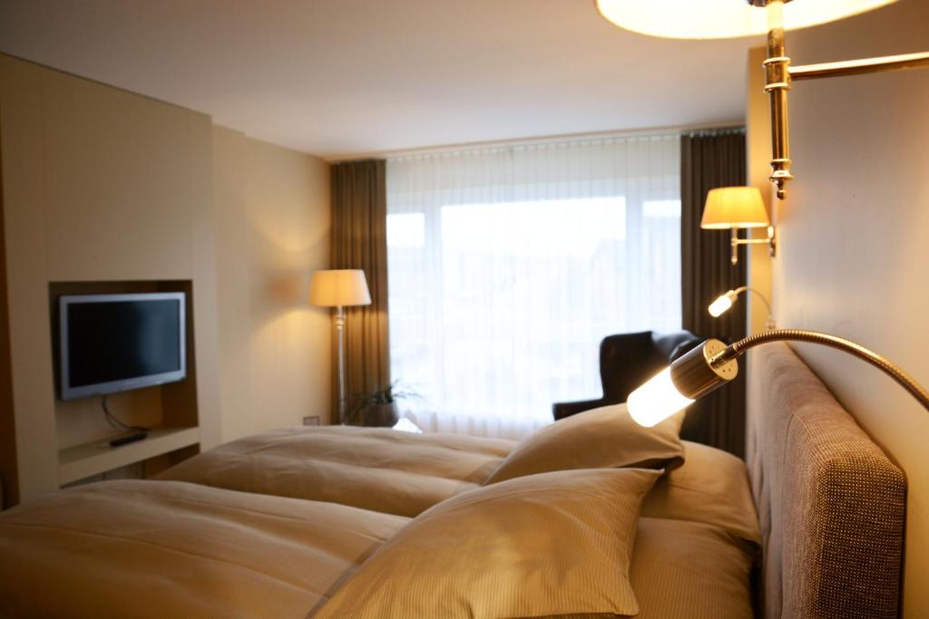 Postel nebo postele na pokoji v ubytování Parkhotel Langenthal