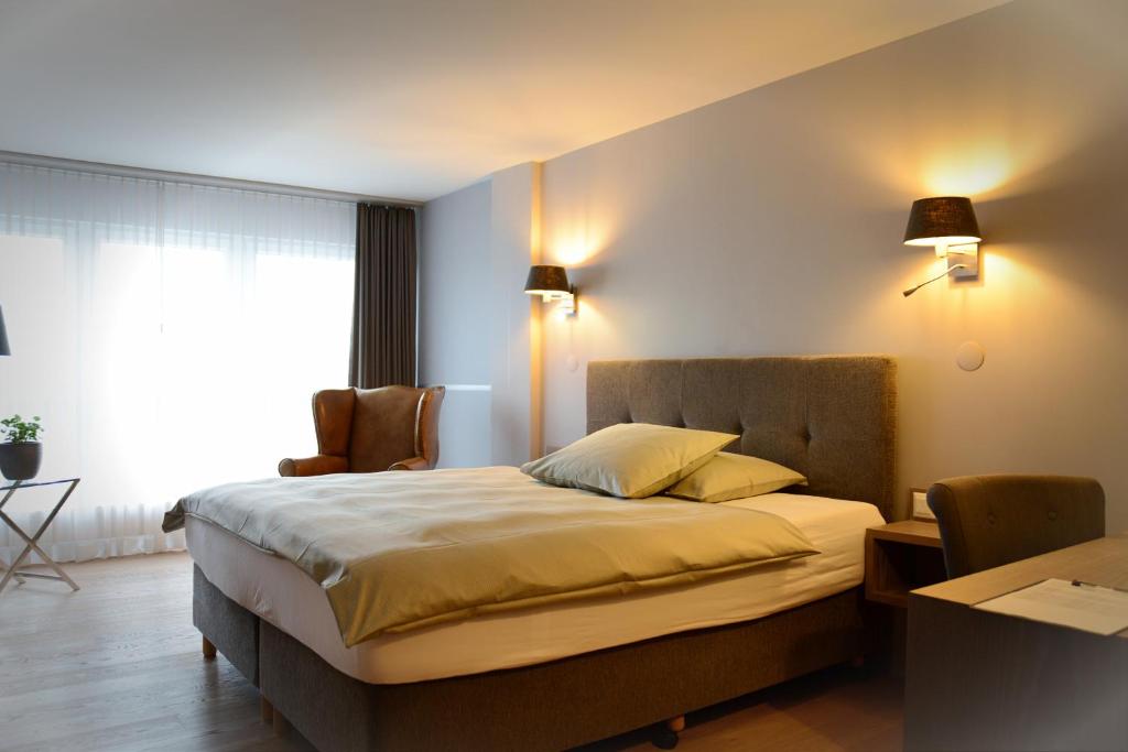 Postel nebo postele na pokoji v ubytování Parkhotel Langenthal