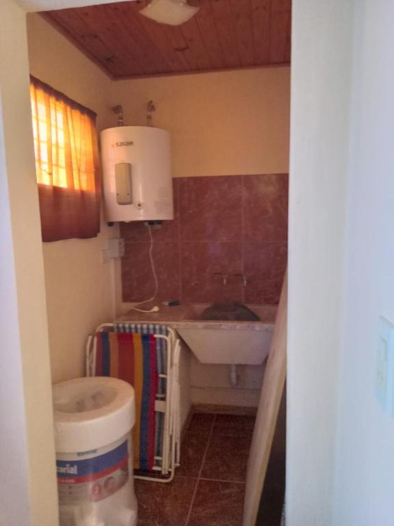 a small bathroom with a sink and a toilet at el sueño del pibe in San Antonio de Areco