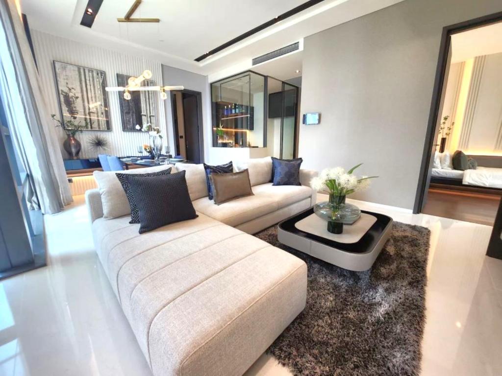 a living room with a couch and a table at Super Luxury Designer Sleeps 6 People in Thonglor in Bangkok