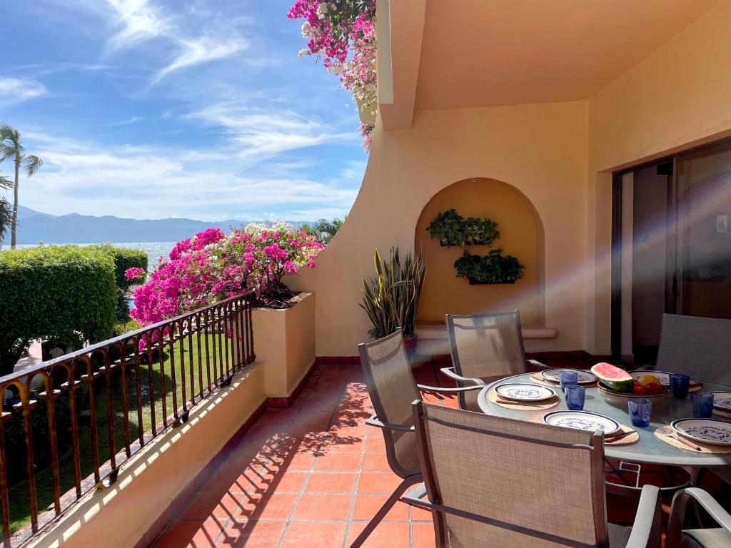 a patio with a table and chairs on a balcony at Velas Vallarta Ocean View in Puerto Vallarta