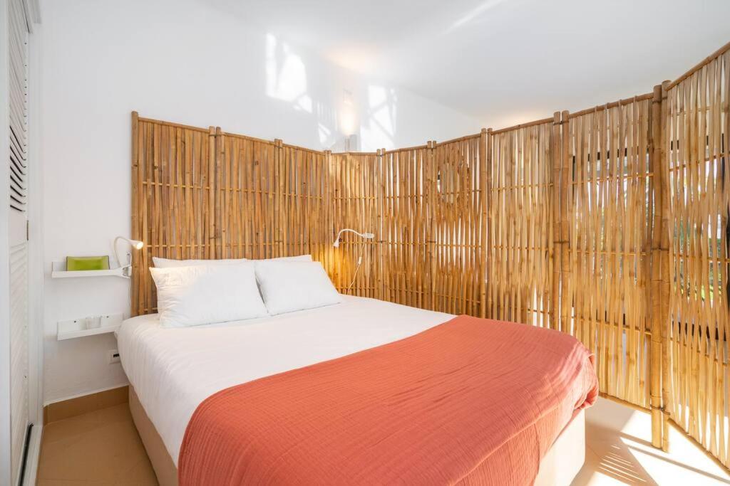 a bedroom with a bed with a wooden wall at Arribas Studio in Albufeira