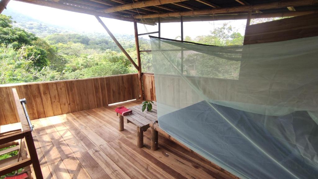 a room with a balcony with a net in it at Sierra Normandia in Cañaveral