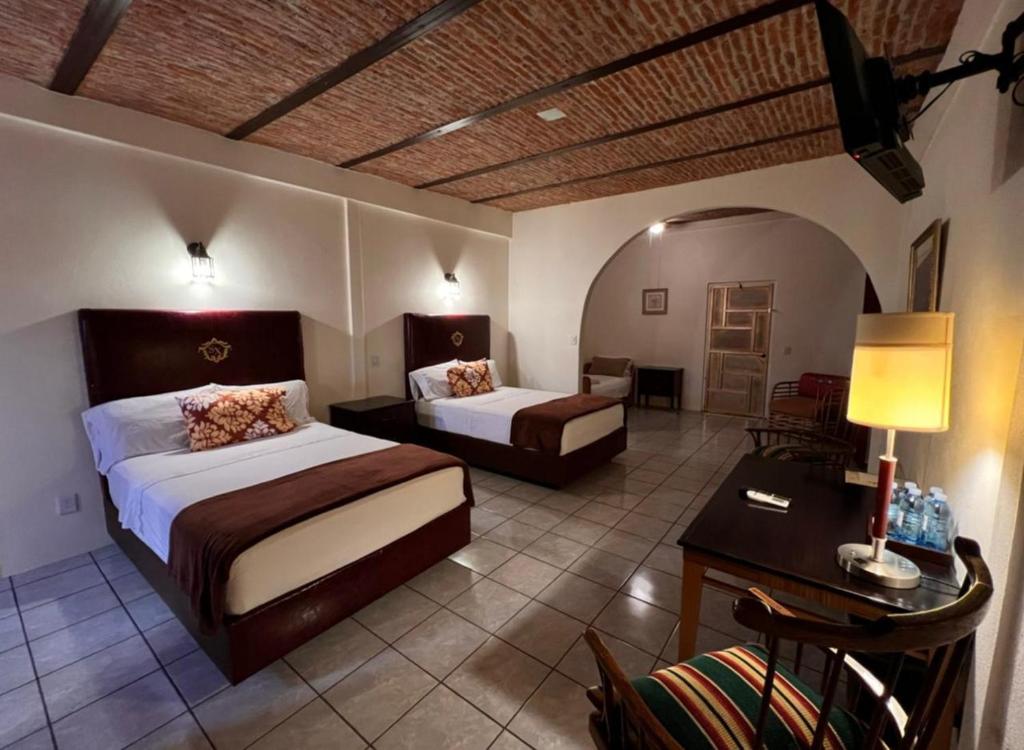 Postel nebo postele na pokoji v ubytování Hotel & Eventos Xalos