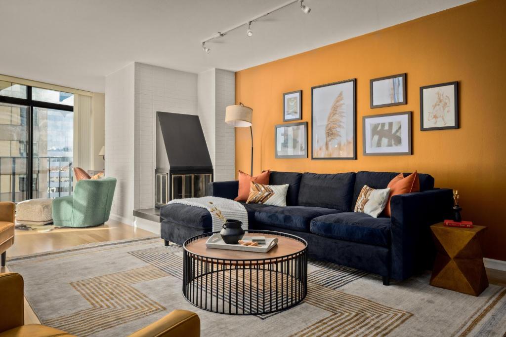 a living room with a blue couch and a table at Urban Gallery Loft - King Bed - Larimer Square in Denver