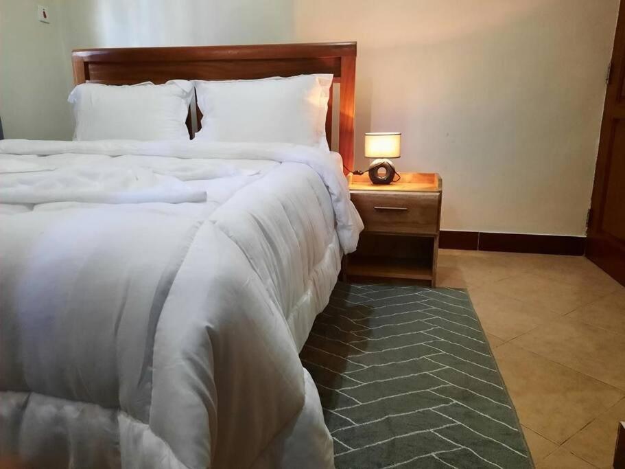 Ένα ή περισσότερα κρεβάτια σε δωμάτιο στο Ellyz Home Stay
