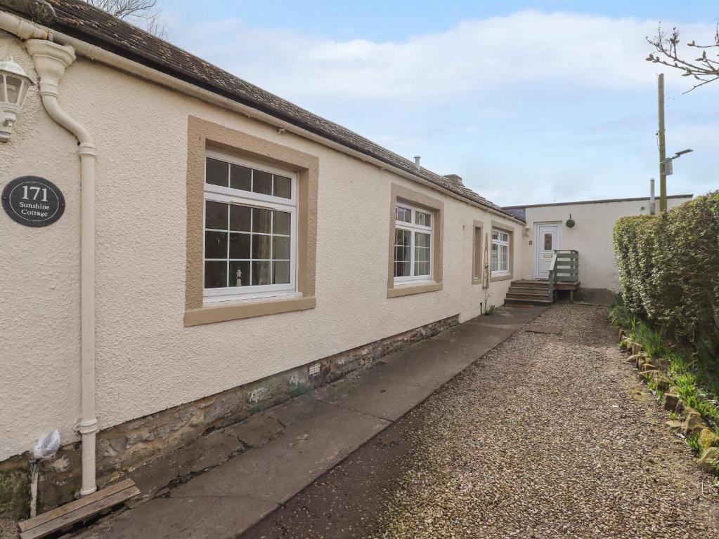 a side view of a building with two windows at Sunshine Cottage in Seahouses