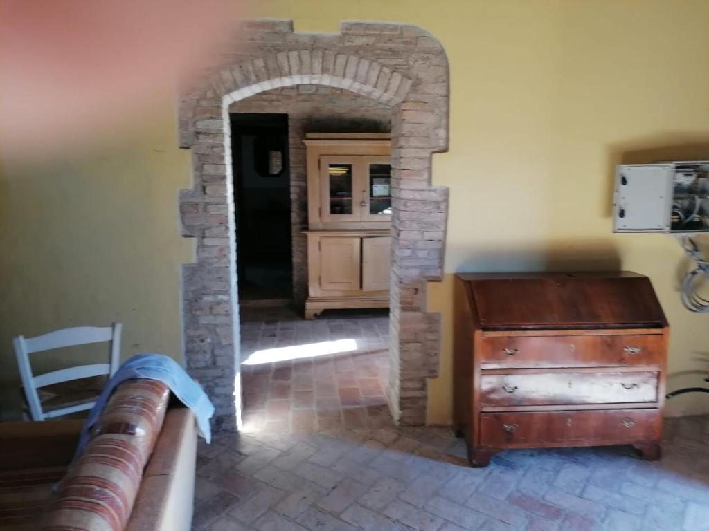 an archway leading into a kitchen with a wooden dresser at CASALE ANTONELLA in Bastia Umbra