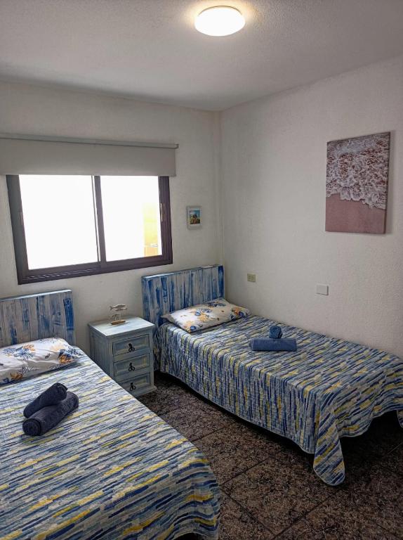 Postel nebo postele na pokoji v ubytování CASA LEO