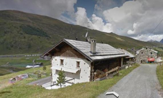 a small building on the side of a road at CASA ARNEIRA in Livigno