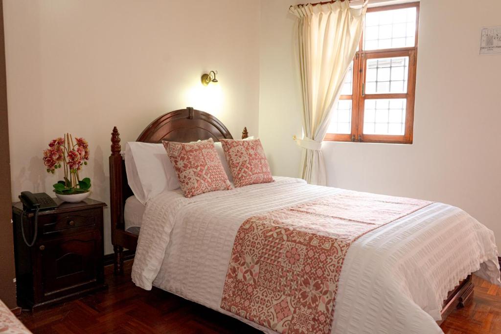Postel nebo postele na pokoji v ubytování Rincón Familiar Hostel Boutique