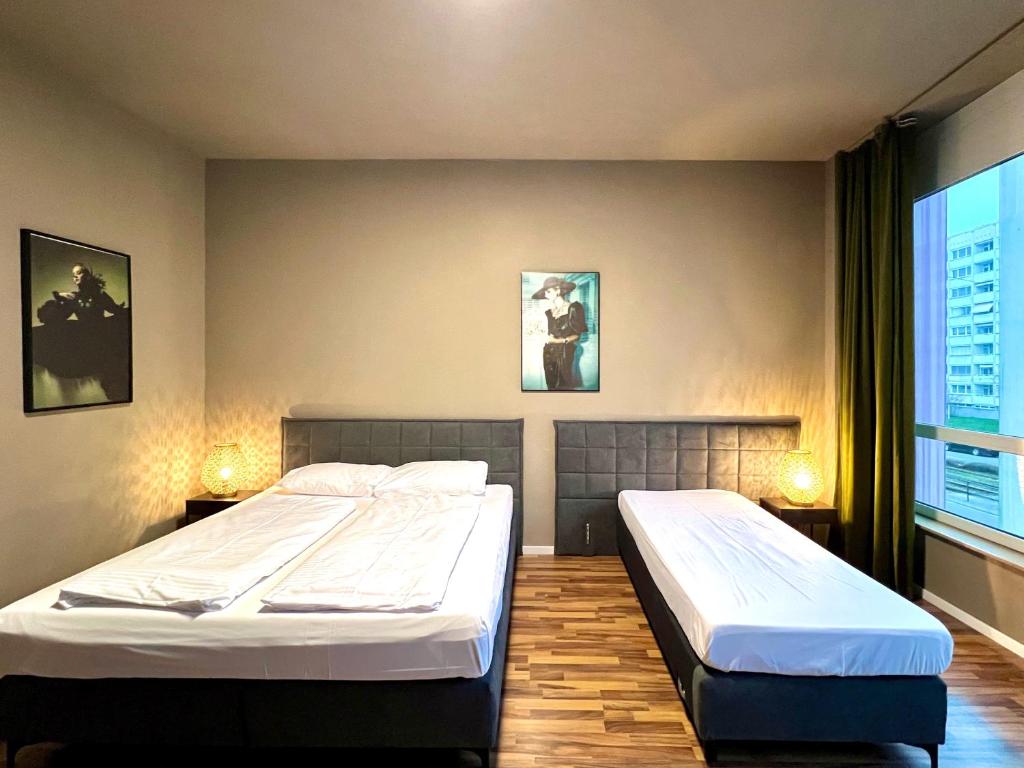 Postel nebo postele na pokoji v ubytování N8 ROOMS - by Leipzig Suites