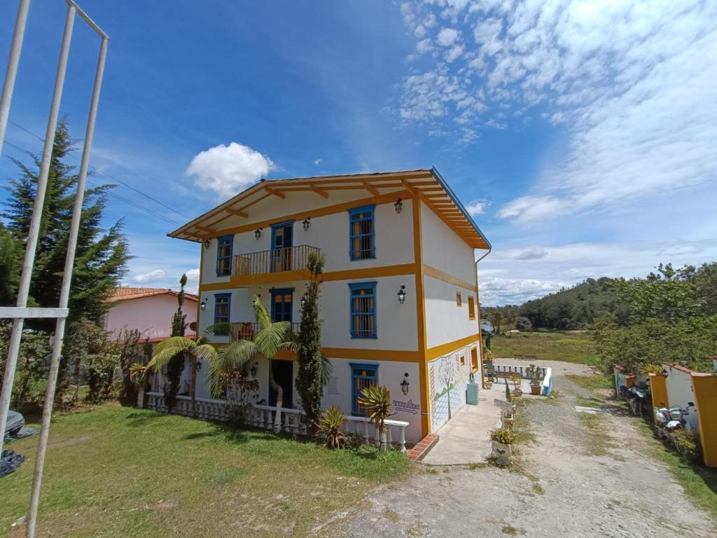 a house on the side of a road at Hotel sol del lago in Guatapé