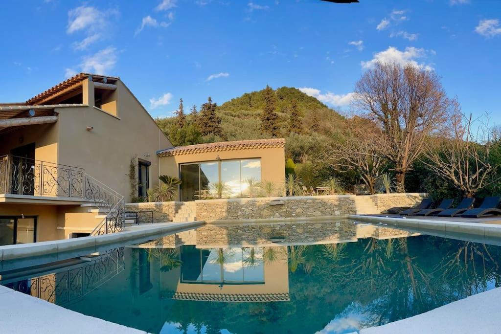 a villa with a swimming pool and a house at La villa Tamaris in Buis-les-Baronnies