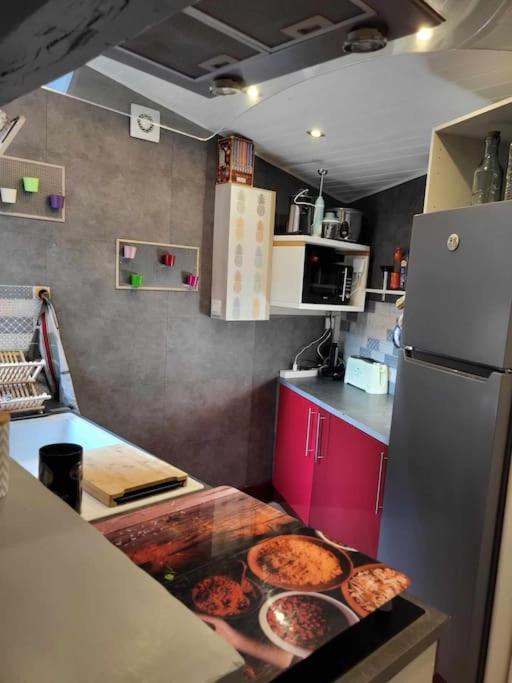 a kitchen with a counter with pizzas on it at Maison de vacances: chez Nirina in Mortagne-sur-Sèvre