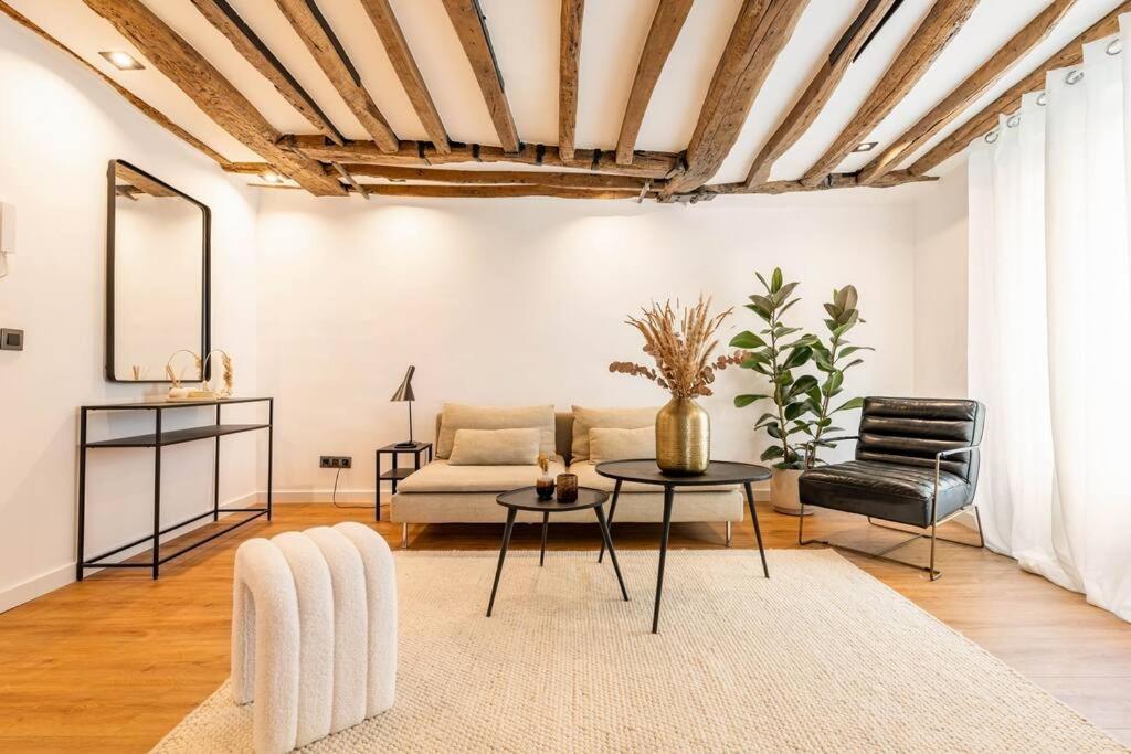 un salon avec un canapé et une table dans l'établissement Magnifique deux chambres au centre de Paris, à Paris