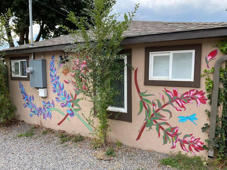 a house with a painting on the side of it at Zootown Bungalow in Missoula