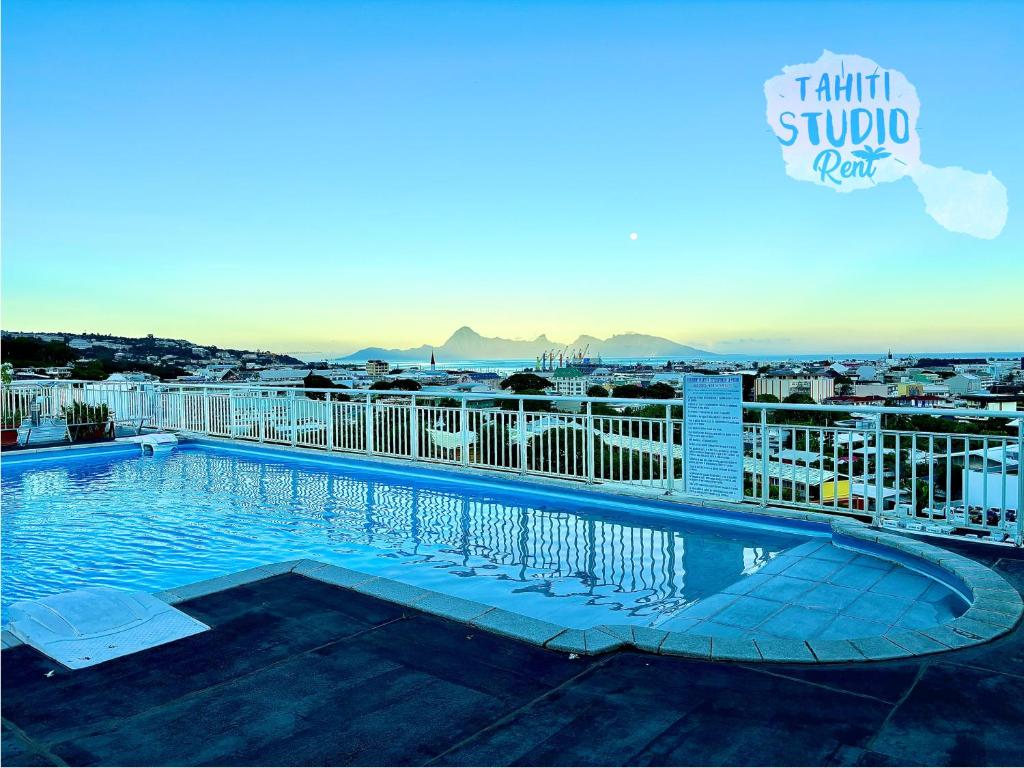 a swimming pool on top of a building at Studio Kaoha Nui - Private apartment in Papeete