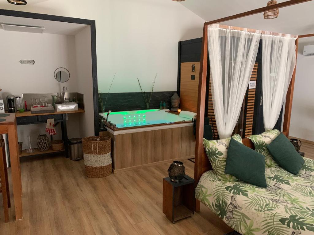 um quarto com uma cama e uma banheira num quarto em L’atelier spa em Codognan