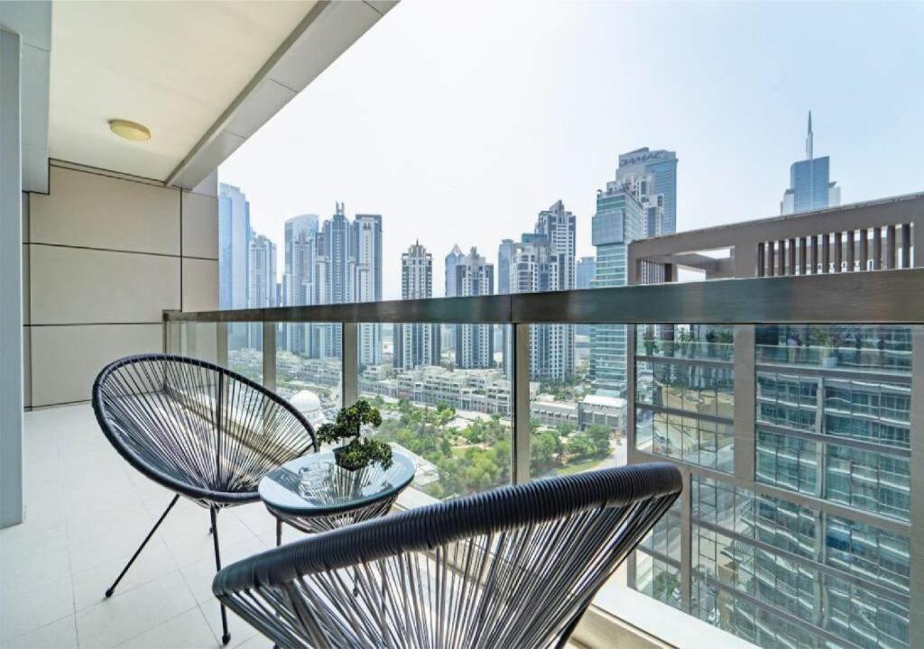 a balcony with two chairs and a table with a view at BEST OFFER! One Bedroom with Downtown Views in Dubai