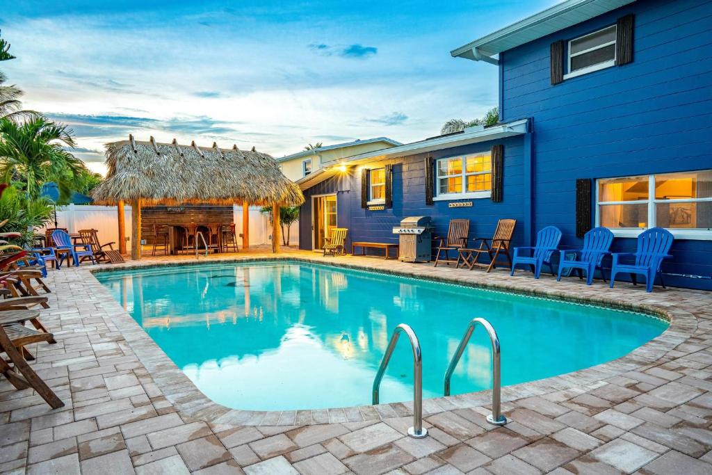 a swimming pool in front of a house at Tiki Blue in Cocoa Beach