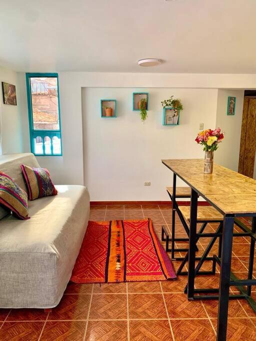 a living room with a couch and a table at Departamento acogedor céntrico en Pisac in Pisac