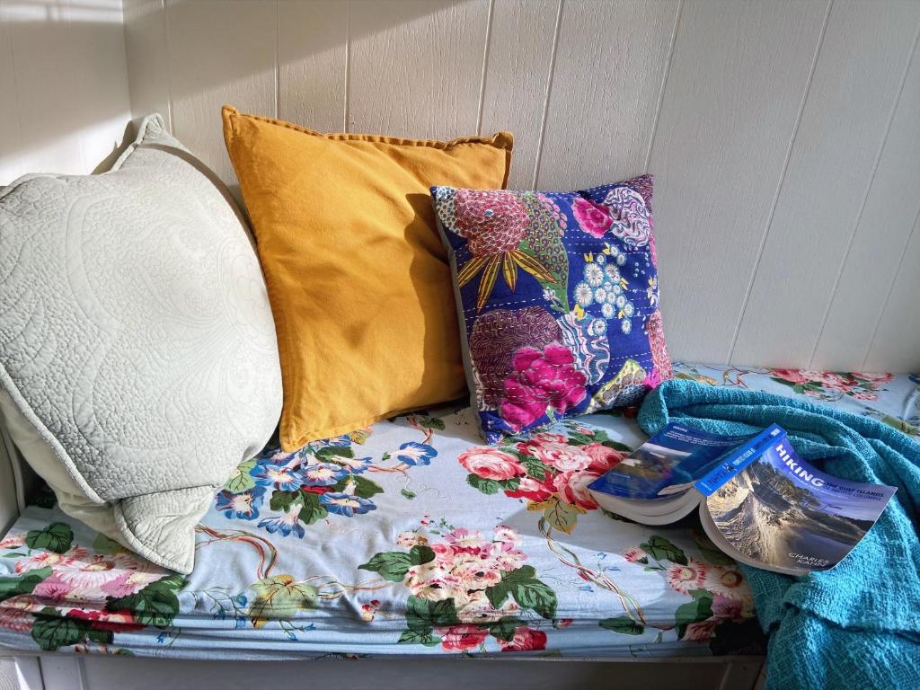 a group of pillows sitting on top of a bed at Wisteria Guest House in Ganges
