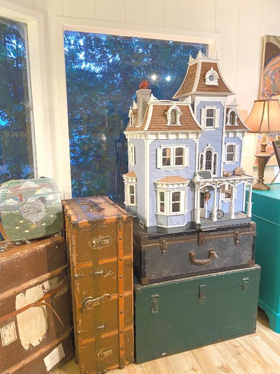 a toy house on top of suitcases with a window at Wisteria Guest House in Ganges